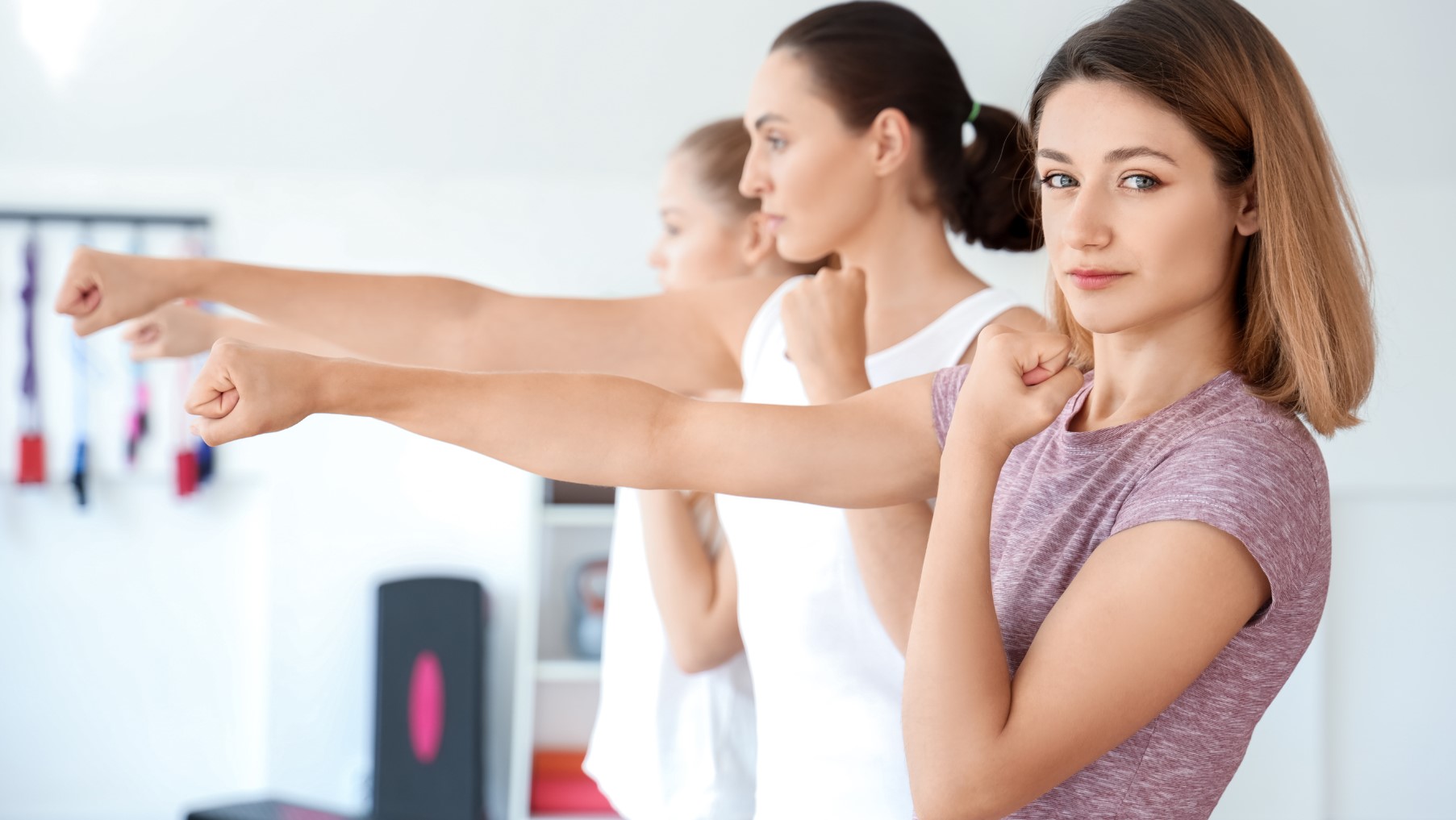 women punching air